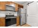 Kitchen showcasing modern stainless steel appliances, wood cabinets, and granite countertops at 8266 Knights Bridge Rd, Charlotte, NC 28210