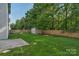 Backyard showcasing green grass, a storage shed, and a wooden fence at 8325 Burgundy Ridge Dr, Harrisburg, NC 28075