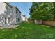 A spacious backyard with green grass, a shed, and a wooden fence perfect for outdoor activities and privacy at 8325 Burgundy Ridge Dr, Harrisburg, NC 28075