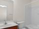Bathroom featuring a single sink vanity and a shower over tub with white tile surround at 8325 Burgundy Ridge Dr, Harrisburg, NC 28075