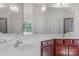 Bathroom featuring a vanity with white counter and dark wood cabinets, and large mirrors at 8325 Burgundy Ridge Dr, Harrisburg, NC 28075