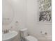 Powder room featuring a toilet, sink with chrome faucet, mirror, and a window at 8325 Burgundy Ridge Dr, Harrisburg, NC 28075