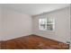 Bright bedroom with wood flooring, crown molding, and a window providing natural light at 8325 Burgundy Ridge Dr, Harrisburg, NC 28075