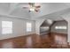 Spacious bedroom with tray ceiling, two windows, and lovely wood floors at 8325 Burgundy Ridge Dr, Harrisburg, NC 28075