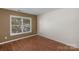 Bedroom featuring wood flooring, neutral paint, and a large window at 8325 Burgundy Ridge Dr, Harrisburg, NC 28075