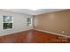 Bedroom featuring wood flooring, neutral paint, and dual windows at 8325 Burgundy Ridge Dr, Harrisburg, NC 28075