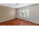 Bedroom featuring wood flooring, neutral paint, and a window at 8325 Burgundy Ridge Dr, Harrisburg, NC 28075