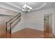 Formal dining room featuring hardwood floors, wainscoting, and decorative chandelier at 8325 Burgundy Ridge Dr, Harrisburg, NC 28075