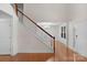 Open foyer featuring hardwood floors, a staircase with white railings, and view into the dining area at 8325 Burgundy Ridge Dr, Harrisburg, NC 28075