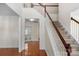 Bright foyer with hardwood floors, staircase, and view into adjacent rooms at 8325 Burgundy Ridge Dr, Harrisburg, NC 28075