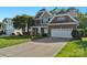 Beautiful two-story home with brick and stone facade, attached two-car garage, and landscaped front yard at 8325 Burgundy Ridge Dr, Harrisburg, NC 28075