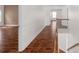 Second floor hallway with wood floors, crown molding, and stairs leading down at 8325 Burgundy Ridge Dr, Harrisburg, NC 28075