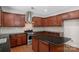 Modern kitchen featuring granite countertops, stainless steel appliances, and a center island at 8325 Burgundy Ridge Dr, Harrisburg, NC 28075