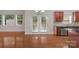 View of living room, kitchen, and access to the backyard from the rear patio doors at 8325 Burgundy Ridge Dr, Harrisburg, NC 28075