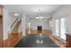 Spacious open concept living room, showing stairs, fireplace, and a view of the kitchen island at 8325 Burgundy Ridge Dr, Harrisburg, NC 28075
