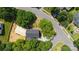 An aerial view of a home with a large enclosed sunroom and mature trees in a residential neighborhood at 8343 Highlander Ct, Charlotte, NC 28269