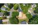 Overhead view of a house, showcasing its sunroom, backyard, and location within a tree-lined neighborhood at 8343 Highlander Ct, Charlotte, NC 28269