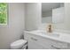 Modern bathroom featuring a white vanity with gold fixtures and a window at 8343 Highlander Ct, Charlotte, NC 28269