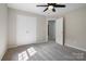 Bright bedroom featuring neutral paint, plush carpet, a ceiling fan, and double door closet at 8343 Highlander Ct, Charlotte, NC 28269