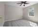 Neutral bedroom with a carpet, a ceiling fan, and a window letting in natural light at 8343 Highlander Ct, Charlotte, NC 28269