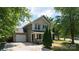 Charming two-story home with a well-manicured lawn, attached garage, and inviting front porch at 8343 Highlander Ct, Charlotte, NC 28269