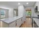Bright, open kitchen featuring an island with granite countertops and stainless steel appliances at 8343 Highlander Ct, Charlotte, NC 28269