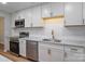 Modern kitchen with white cabinetry, stainless steel appliances, and granite countertops at 8343 Highlander Ct, Charlotte, NC 28269
