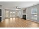 Spacious living room with a fireplace, lots of natural light and hardwood style flooring at 8343 Highlander Ct, Charlotte, NC 28269