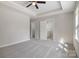 Spacious main bedroom with a tray ceiling, ceiling fan, and doorway to bathroom at 8343 Highlander Ct, Charlotte, NC 28269