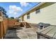 This view of the backyard shows the home, the deck with stairs, and a bench seat against the fence at 8529 Indian Summer Trl, Harrisburg, NC 28075