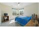 Comfortable bedroom with plentiful windows, patterned bedding, and a ceiling fan at 8529 Indian Summer Trl, Harrisburg, NC 28075