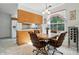 Cozy dining area with a wooden table, matching chairs, and natural light at 8529 Indian Summer Trl, Harrisburg, NC 28075