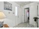Bright entryway featuring tile flooring, a front door with sidelight, and white walls at 8529 Indian Summer Trl, Harrisburg, NC 28075