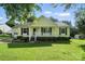 Charming single-story home featuring a welcoming front porch and well-manicured lawn at 8529 Indian Summer Trl, Harrisburg, NC 28075