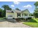 This charming, single-story home has a one-car garage and manicured landscaping at 8529 Indian Summer Trl, Harrisburg, NC 28075