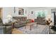 Bright living room showcasing ample seating and natural light from a large window at 8529 Indian Summer Trl, Harrisburg, NC 28075