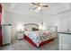 Serene bedroom with tray ceiling, floral bedding, carpet and plentiful furniture at 8529 Indian Summer Trl, Harrisburg, NC 28075