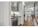 Chic butler's pantry area with wine storage, dark countertop, white cabinets and hardwood flooring at 1045 Waxhaw Crossing Dr, Waxhaw, NC 28173