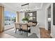 Elegant dining room featuring modern light fixture, stylish chairs, large windows, and white and gray decor at 1045 Waxhaw Crossing Dr, Waxhaw, NC 28173
