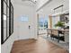 Inviting foyer with hardwood floors, a white front door with glass panes, and a view into the dining area at 1045 Waxhaw Crossing Dr, Waxhaw, NC 28173