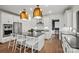 Modern white kitchen featuring stainless steel appliances, an island with seating and pendant lighting at 1045 Waxhaw Crossing Dr, Waxhaw, NC 28173