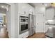 Kitchen boasts stainless steel double ovens and refrigerator in a modern white cabinet design at 1045 Waxhaw Crossing Dr, Waxhaw, NC 28173