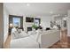 Comfortable living room featuring a fireplace, large sectional, neutral tones, wood floors, and ample natural light at 1045 Waxhaw Crossing Dr, Waxhaw, NC 28173