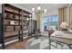 Modern home office with built-in shelves, a comfortable chair, a large window overlooking the pool, and a stylish desk at 1045 Waxhaw Crossing Dr, Waxhaw, NC 28173