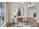 Bright home office features contemporary decor, desk, horse art and hardwood floors with large window and natural light at 1045 Waxhaw Crossing Dr, Waxhaw, NC 28173