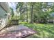 A spacious backyard with a concrete patio and a garden framed by mature trees at 11305 Hunters Landing Dr, Charlotte, NC 28273