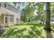Green backyard with grassy lawn bordered by a wood fence and mature trees at 11305 Hunters Landing Dr, Charlotte, NC 28273