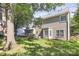 A lush backyard, showing a section of the house, and a few shade trees at 11305 Hunters Landing Dr, Charlotte, NC 28273