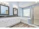 Bathroom with double sink vanity, granite countertop, tub and shower enclosure at 11305 Hunters Landing Dr, Charlotte, NC 28273