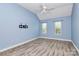 Bright bedroom with vaulted ceiling, ceiling fan, wood-look flooring and two large windows at 11305 Hunters Landing Dr, Charlotte, NC 28273